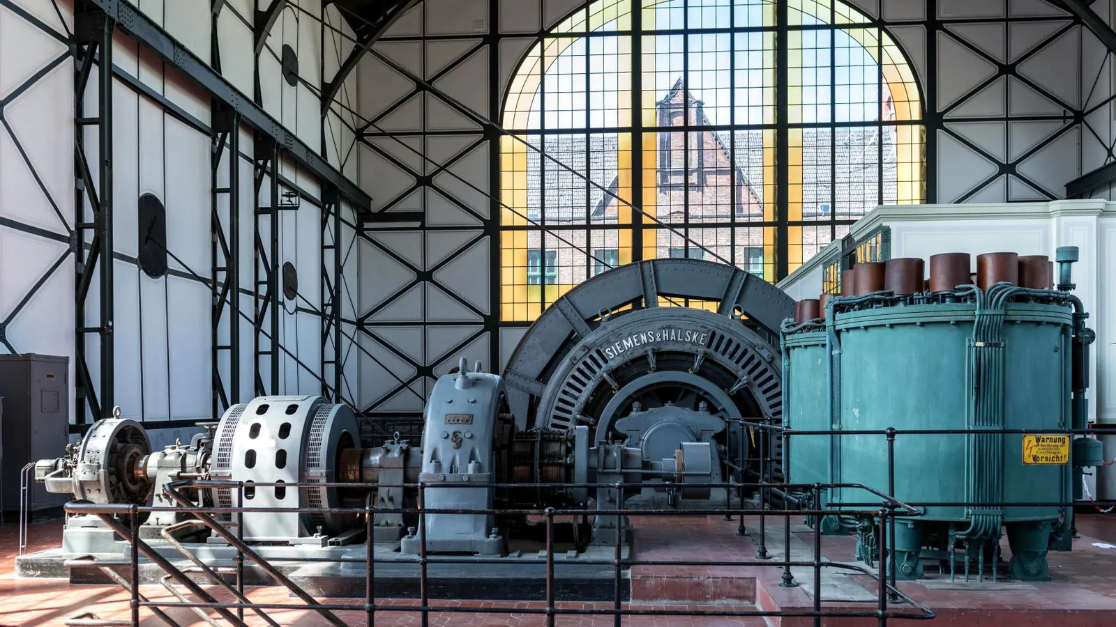 A diesel generator exhaust stack in a fenced industrial yard