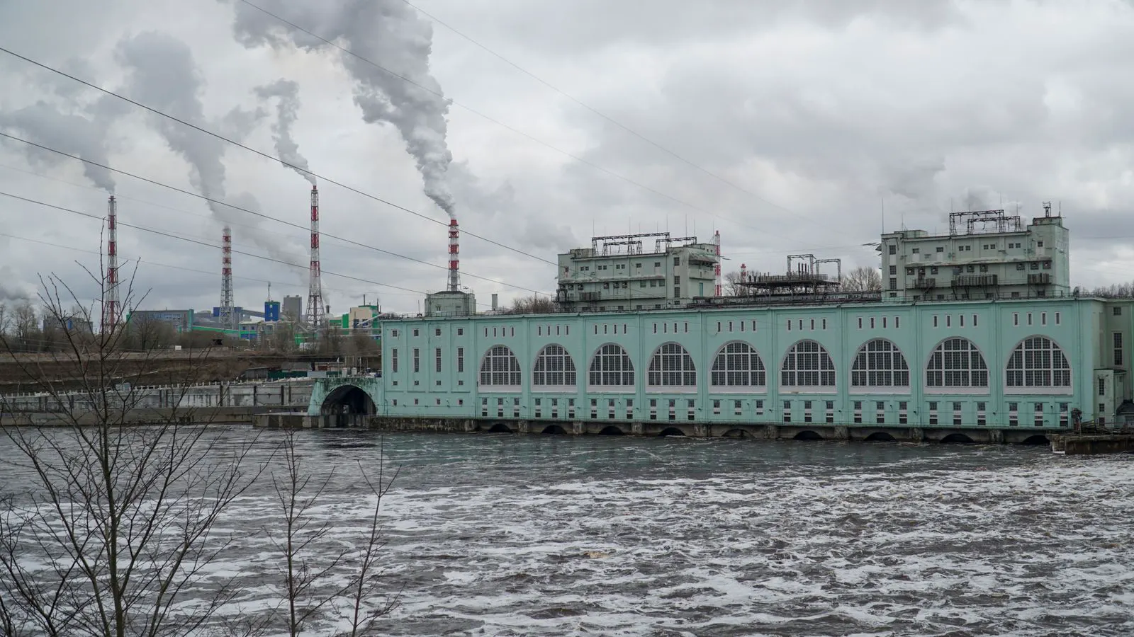Large industrial diesel generator unit installed outdoors near a building