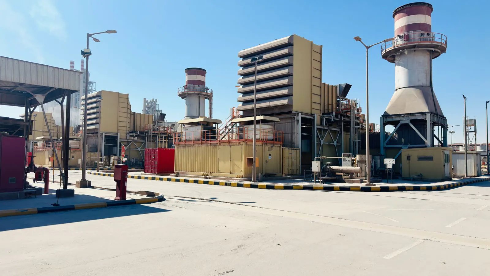 A diesel generator set sitting on a steel base frame outdoors.