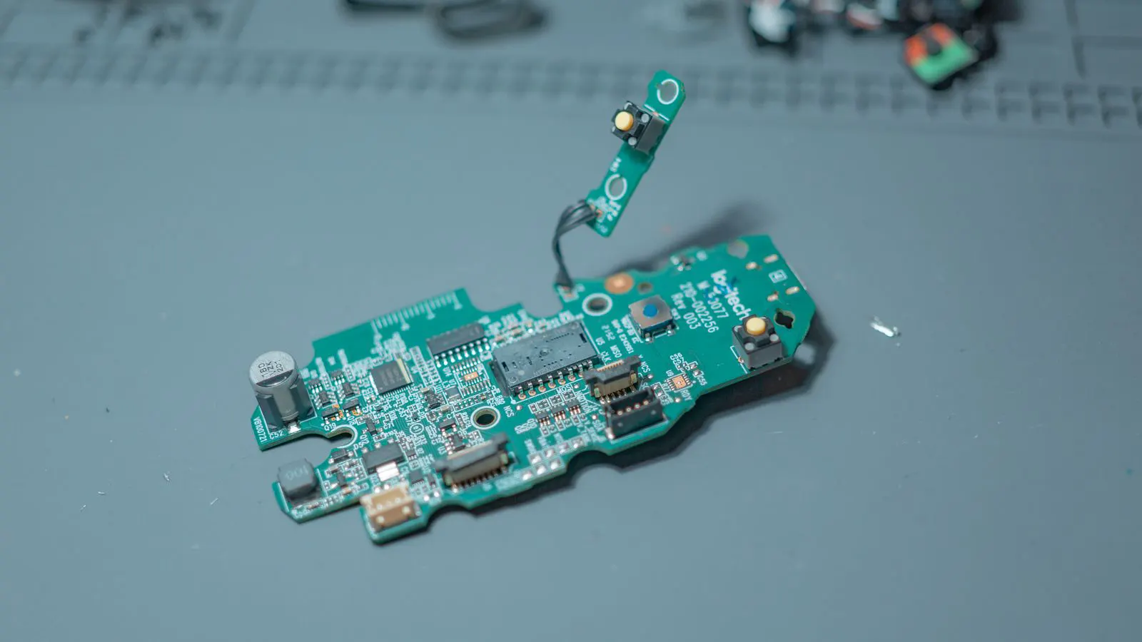 A worker inspecting electronic components on a production line