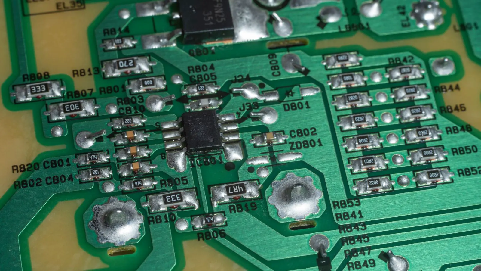 A close up view of a printed circuit board with surface mount components