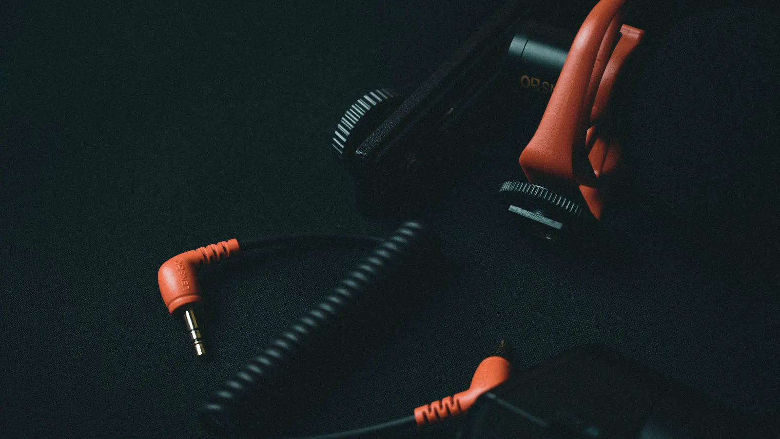 Close up of black strain relief clamps securing a multi-conductor cable bundle