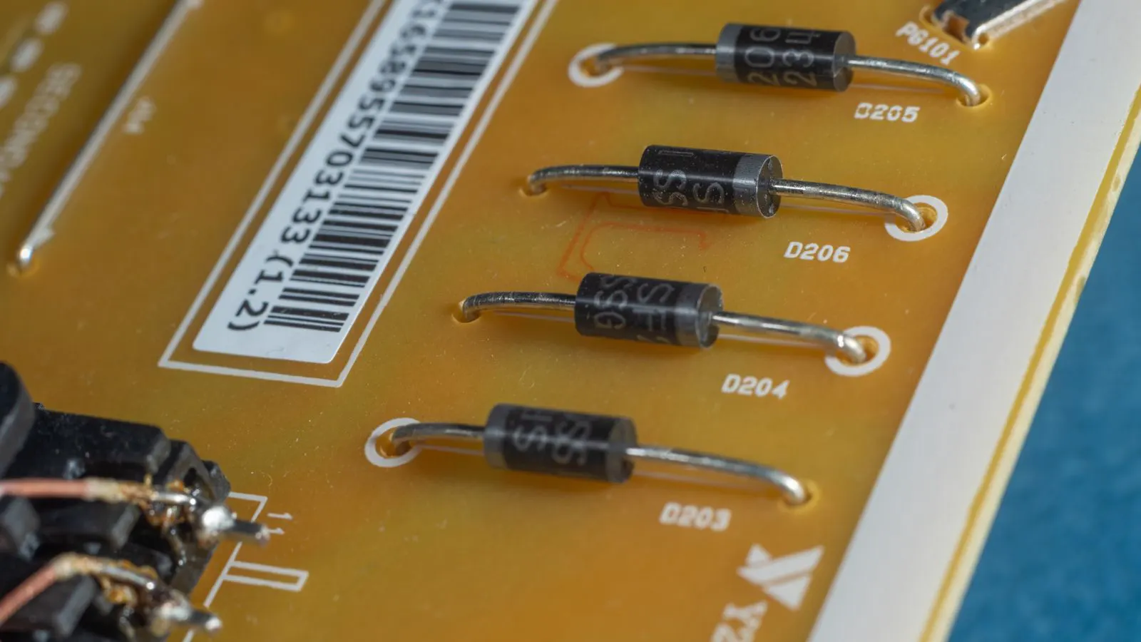 Close view of a wire harness being routed through a metal panel