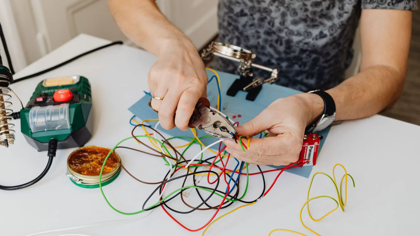 A technician uses a multimeter to test a single core cable