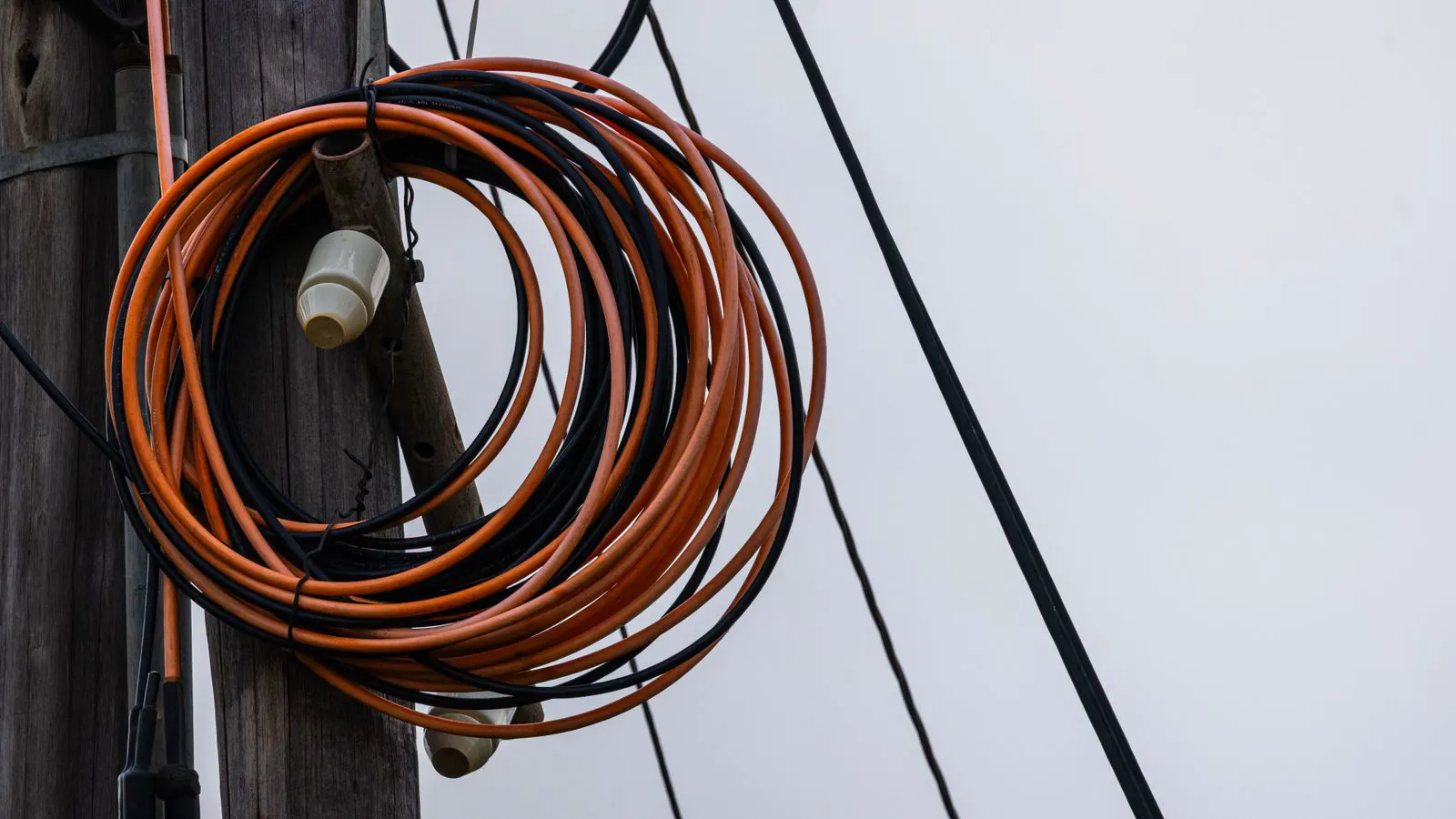A large coil of power cable resting on a transport container at a port