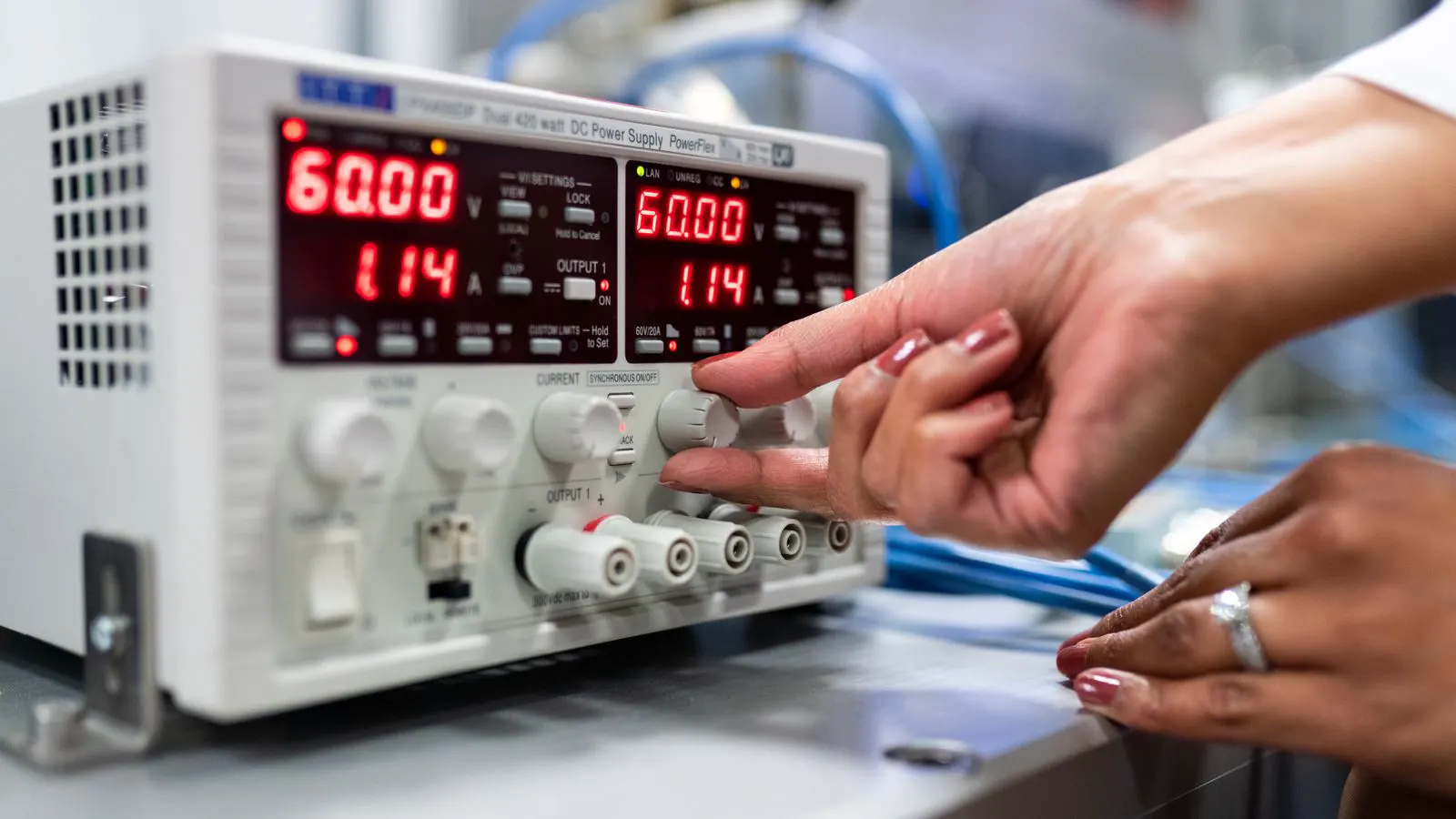 Oscilloscope trace showing low ripple output on a laboratory bench