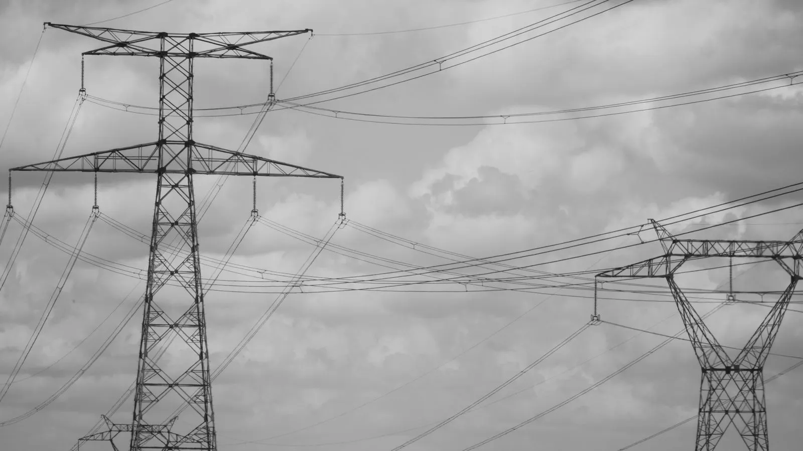 A row of industrial power supply units mounted in a metal rack.
