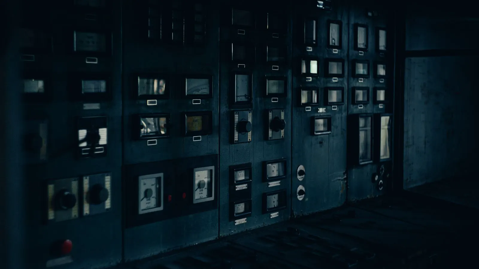 A row of low-voltage switchgear cabinets in a clean electrical room.