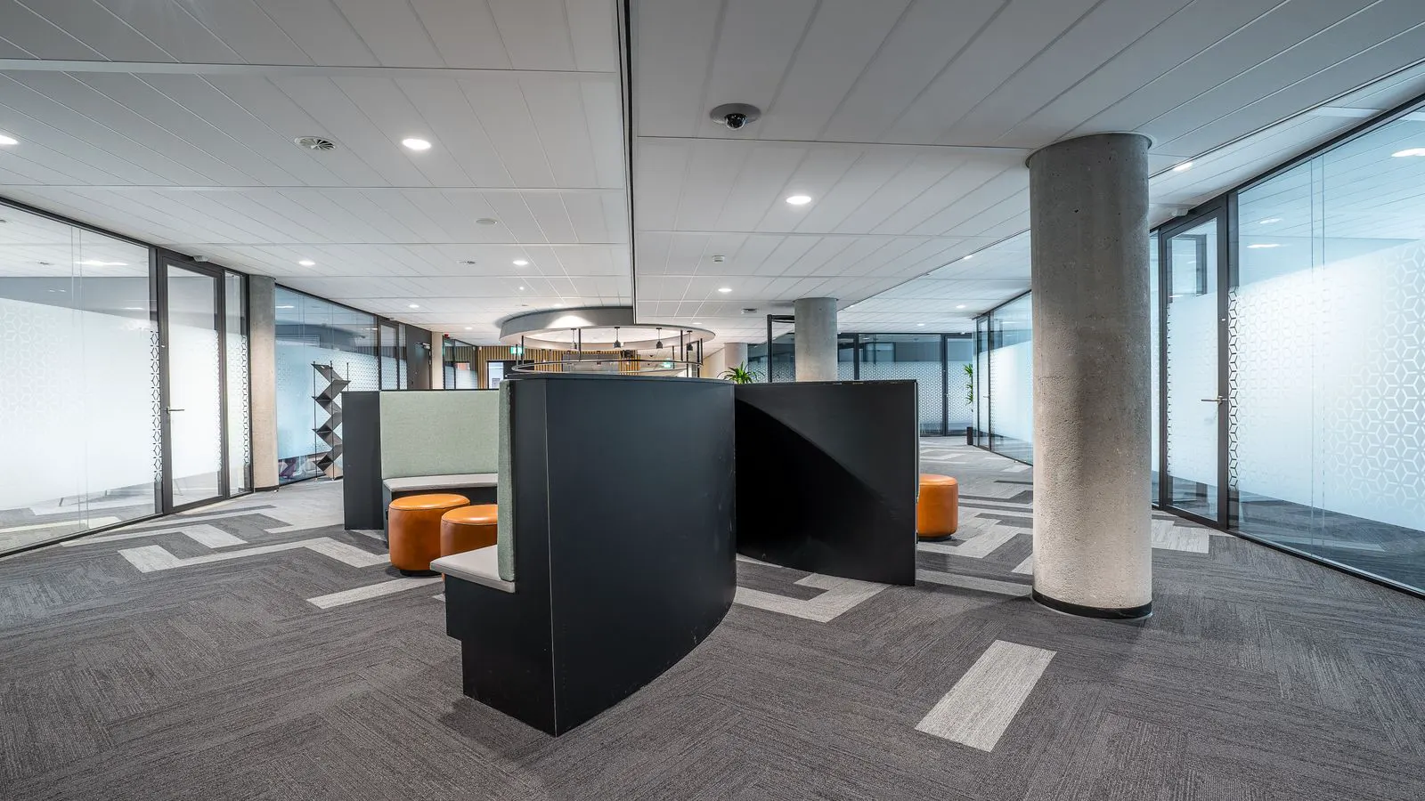 Modern LED office lighting fixtures installed in an open-plan workspace