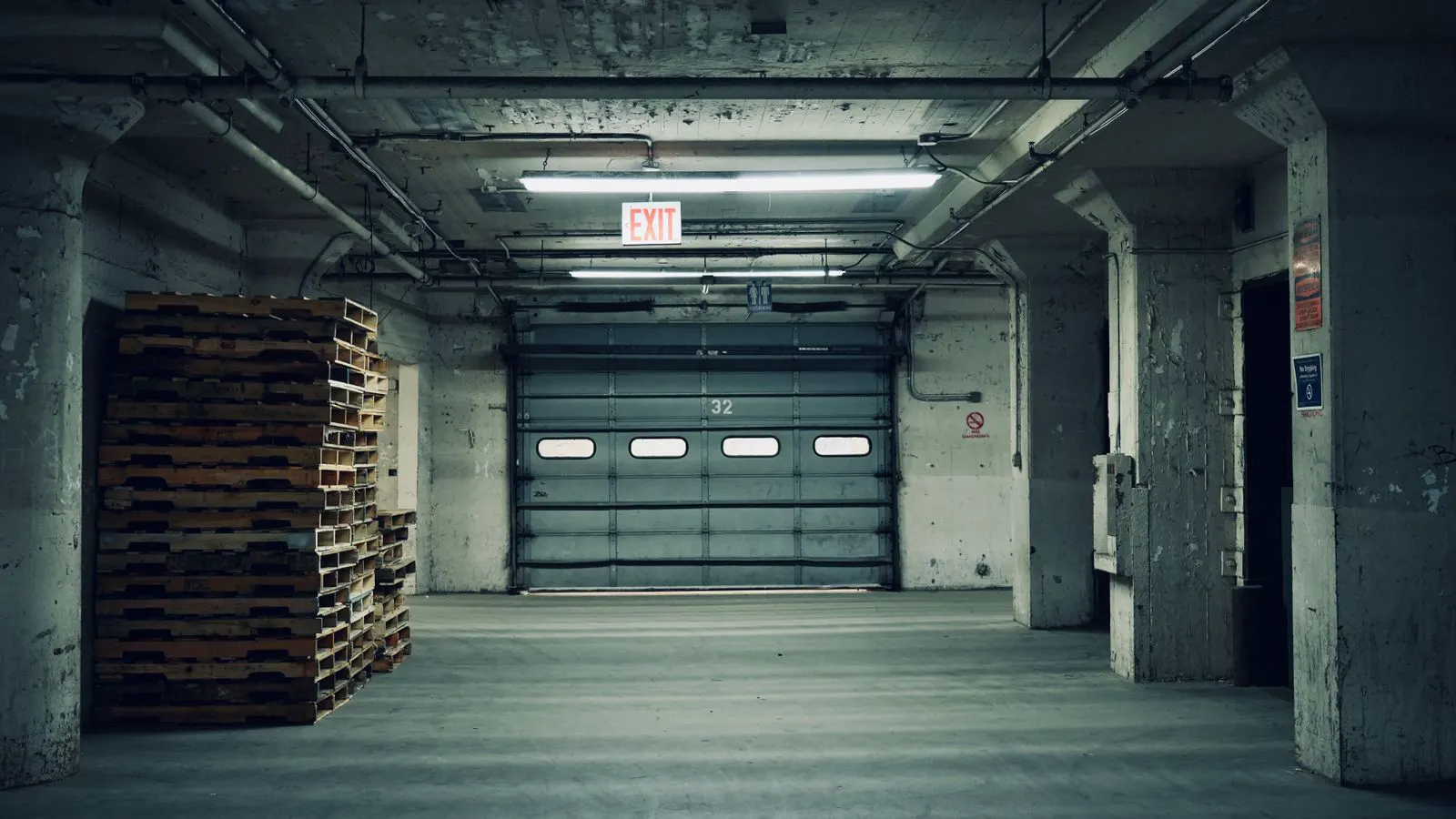 LED high bay fixture mounted inside a large industrial warehouse