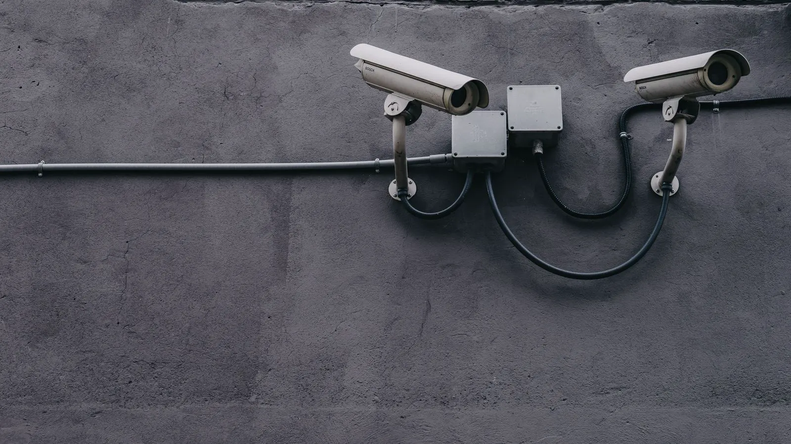 A weather-resistant analog surveillance camera mounted on a pole.