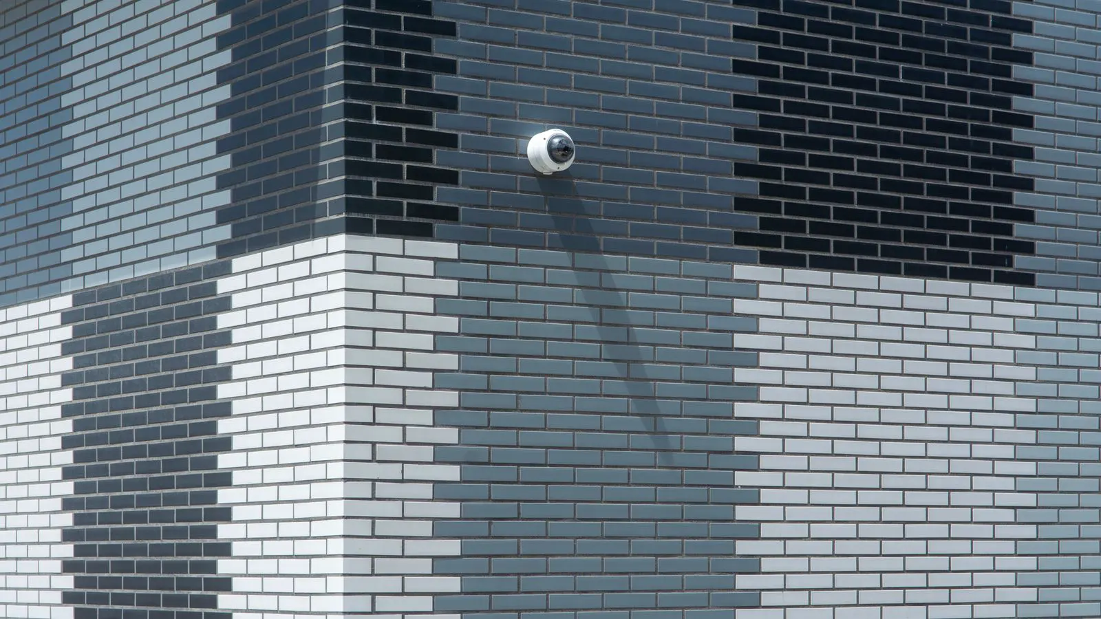 Technician reviewing camera coverage and lighting at a site