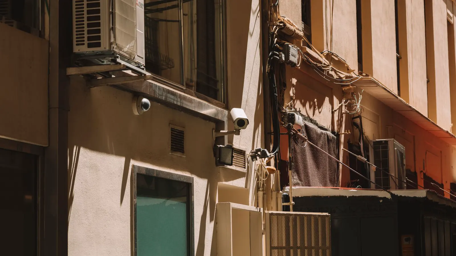 A professional installing a camera on a building pole