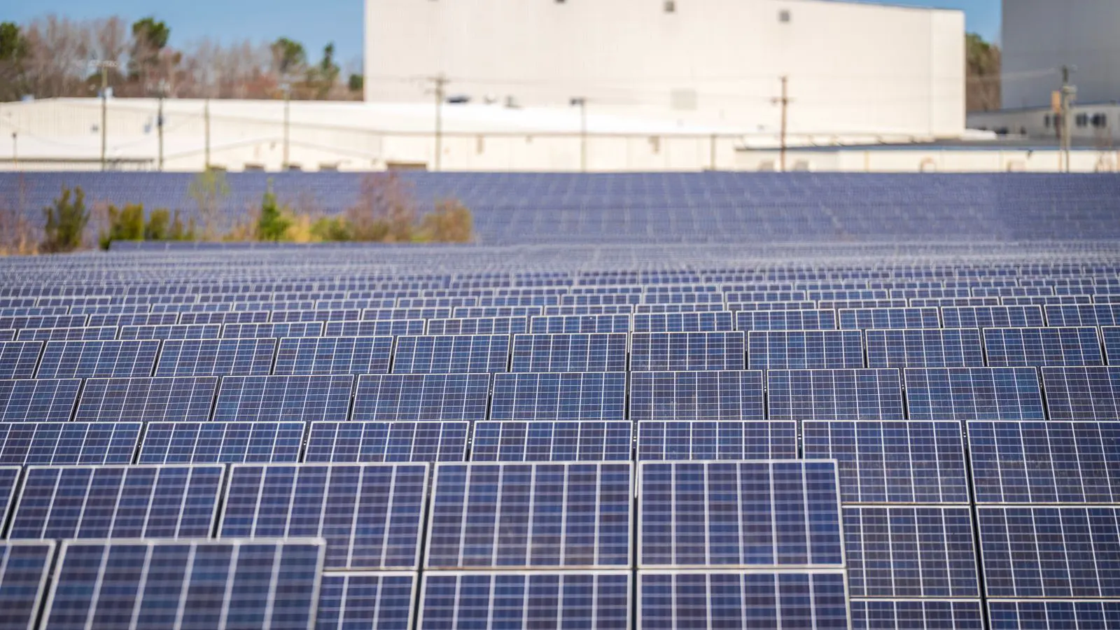 Technicians inspecting photovoltaic modules in a testing facility