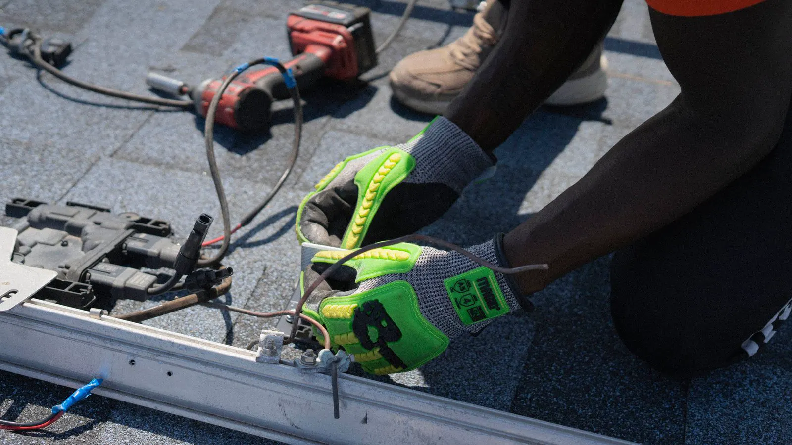 Workers installing solar racking on a commercial rooftop
