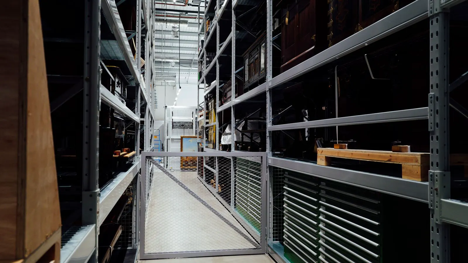 Steel racking components stacked on racks in a warehouse