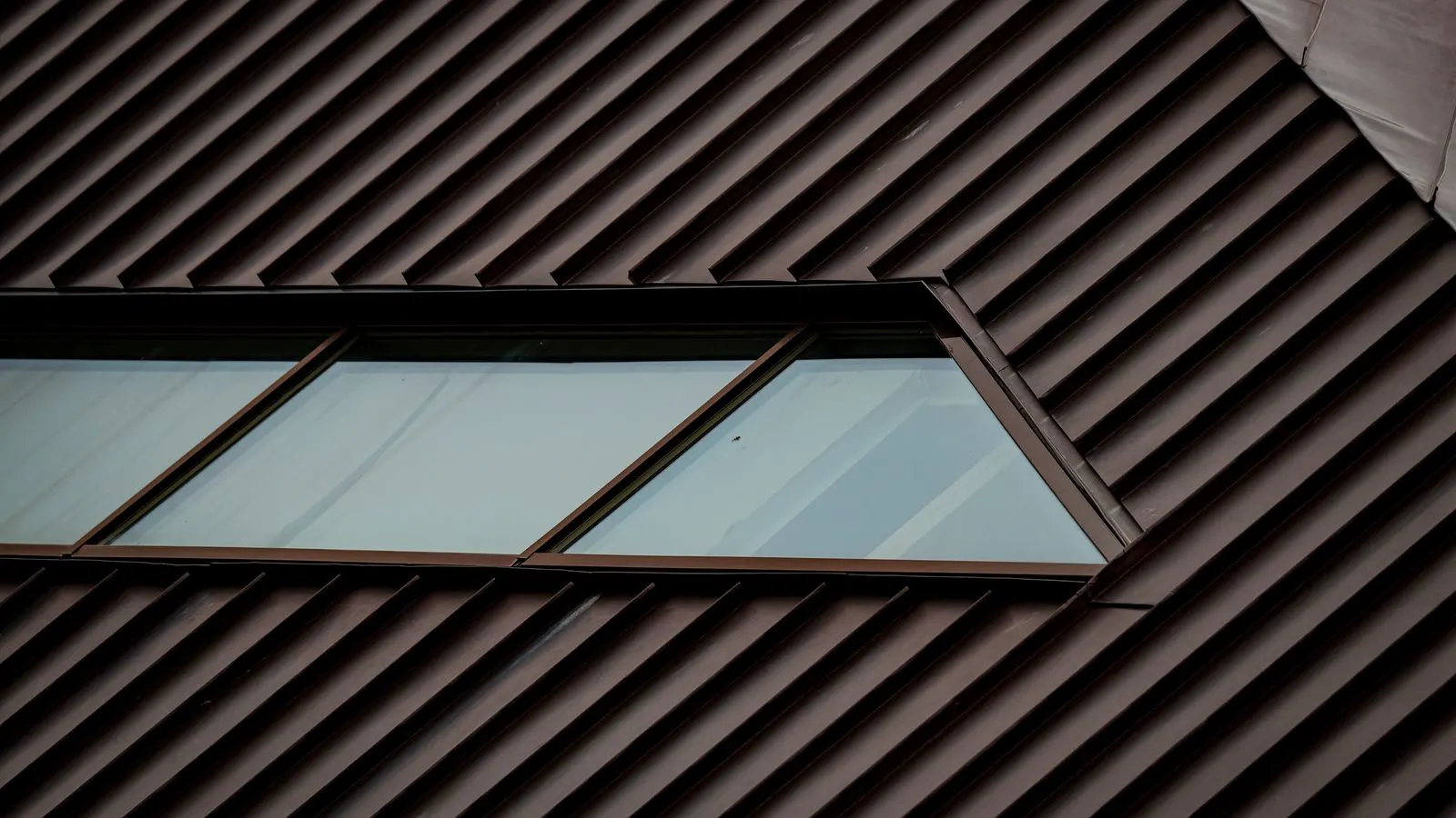 close up of metal roof fasteners under snow