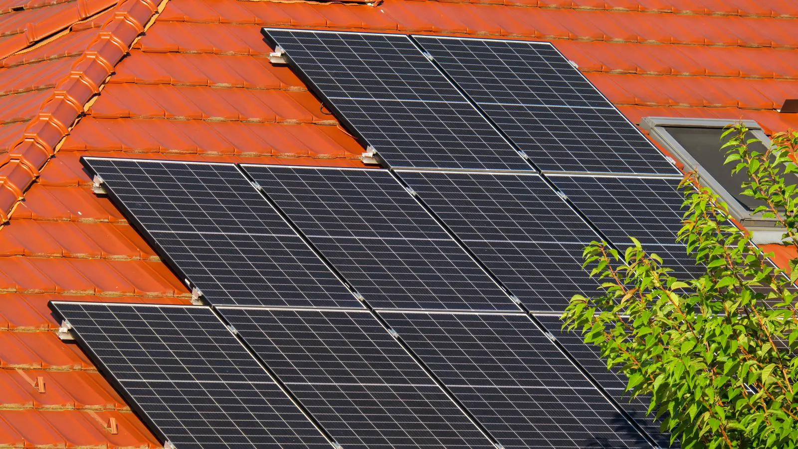 Solar panels mounted on a pitched roof showing upward force vectors