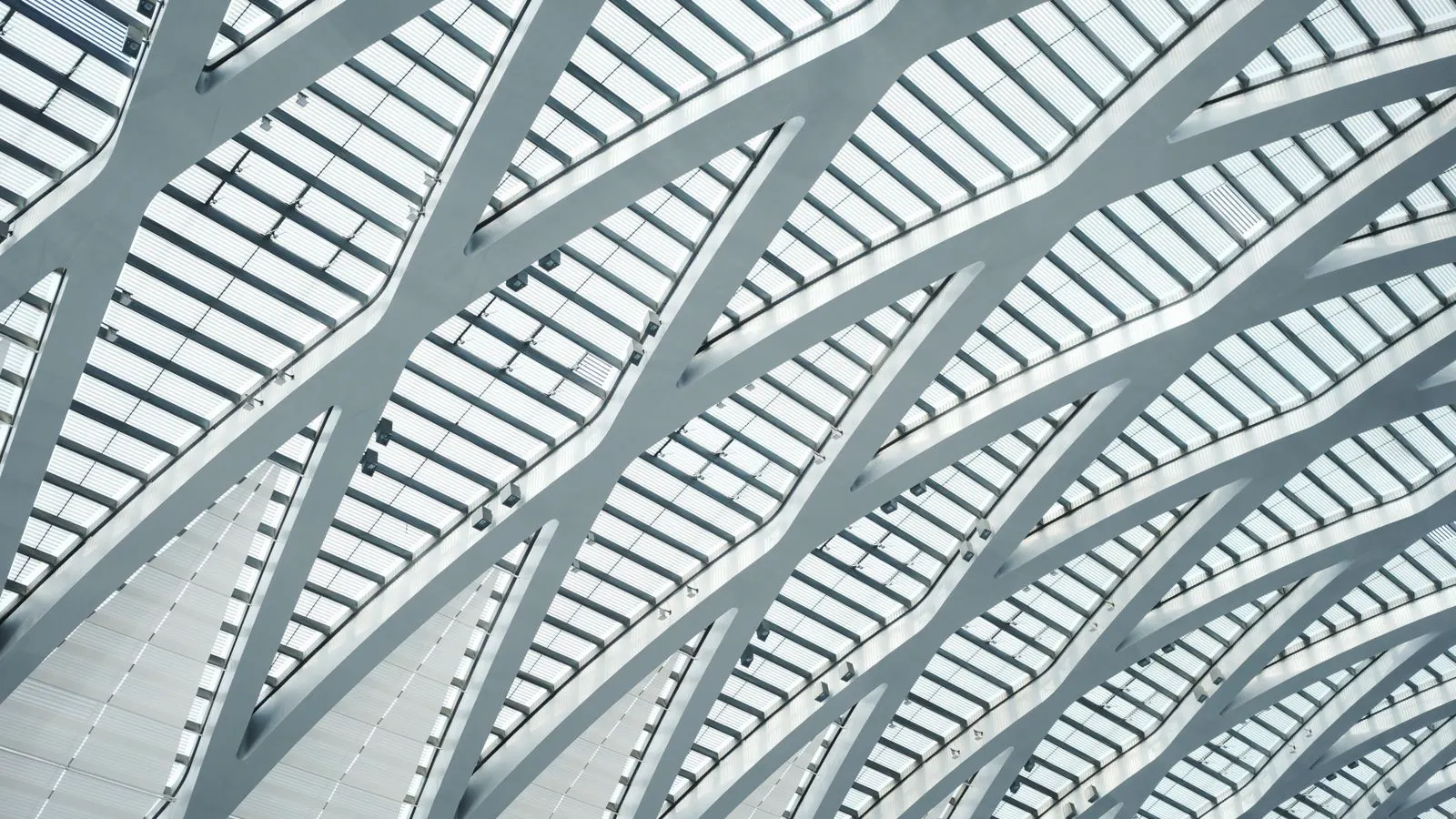 Galvanized steel racking rails mounted on a commercial metal roof panel.