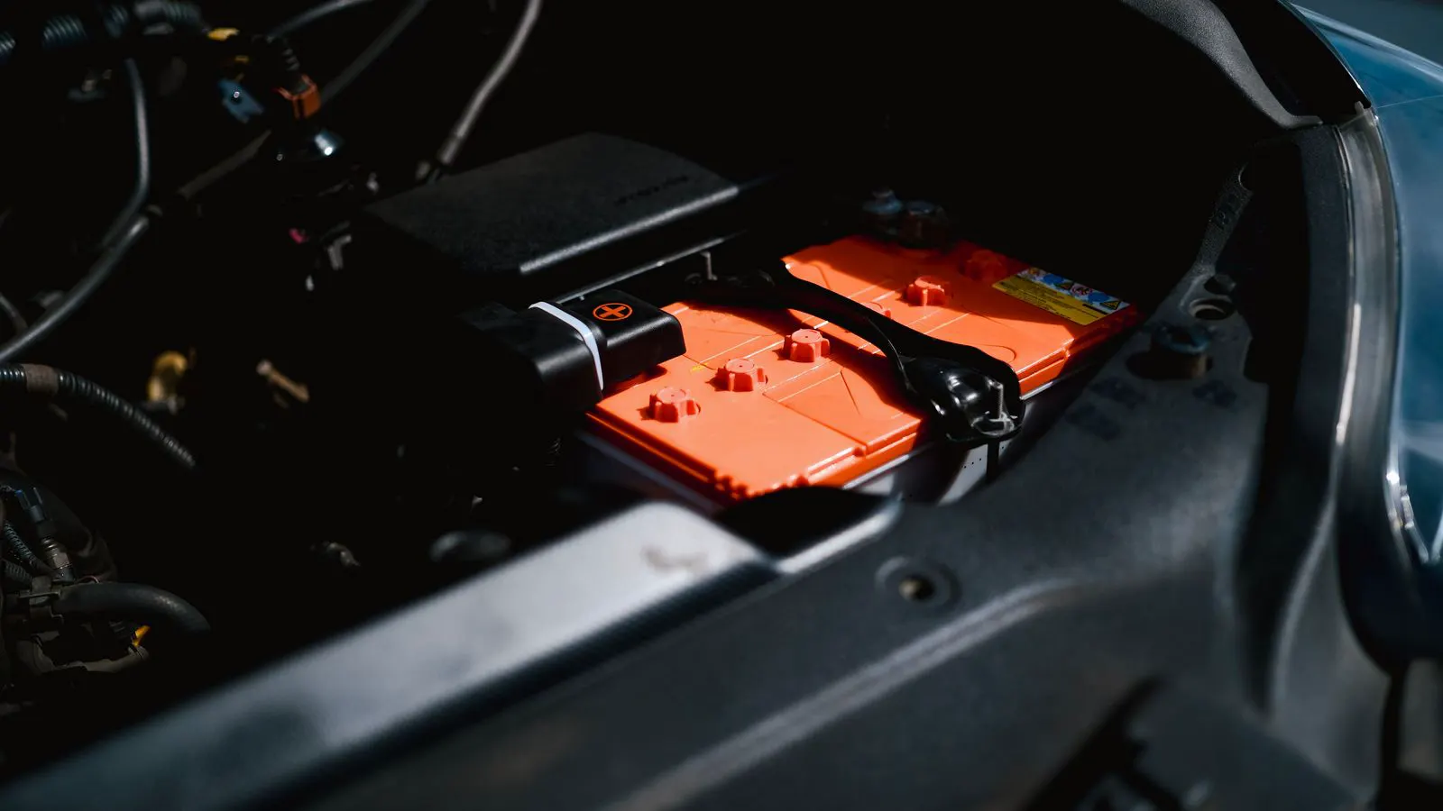 Engineer inspecting lithium battery cells inside a testing chamber