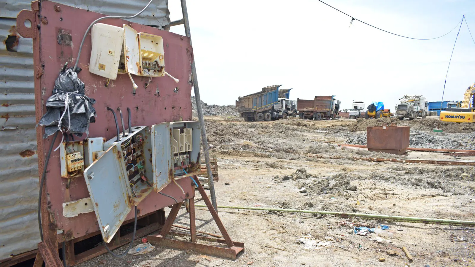 Electrical components and cabling laid out on a construction site.