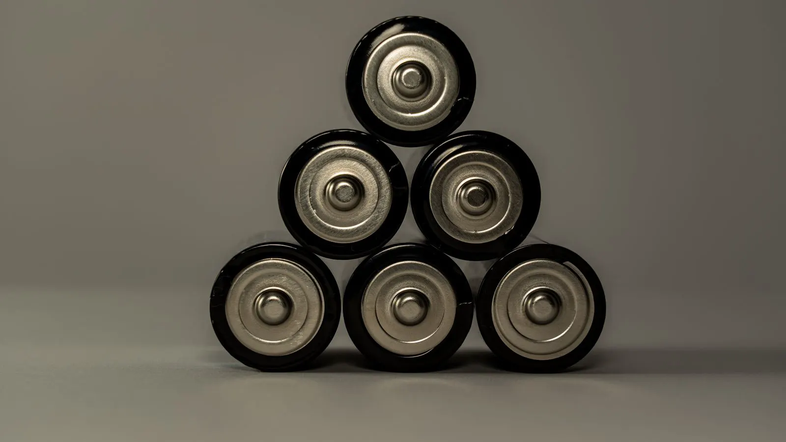 Rows of white battery containers arranged in an open yard.