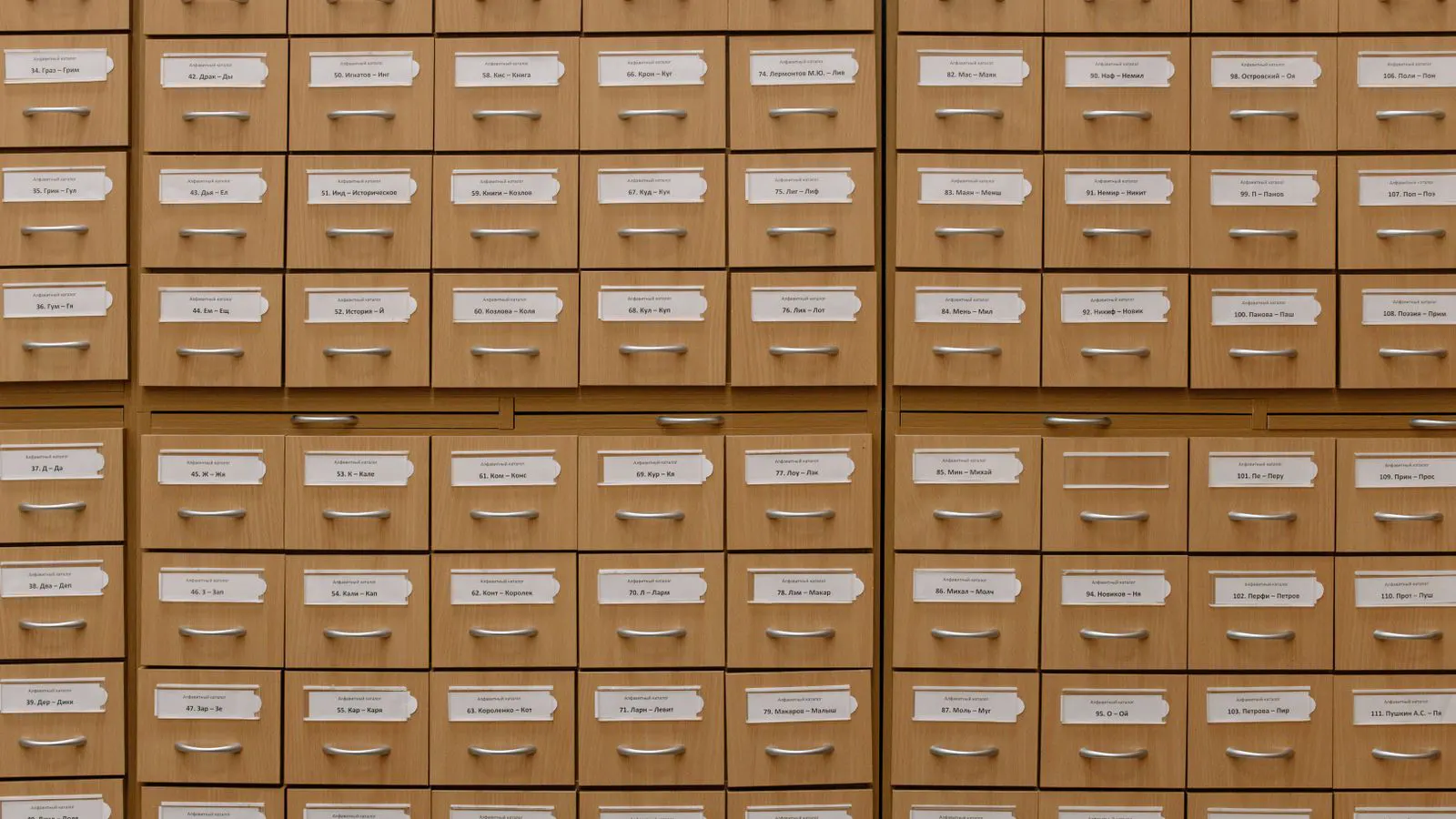 A row of white battery energy storage cabinets in a facility