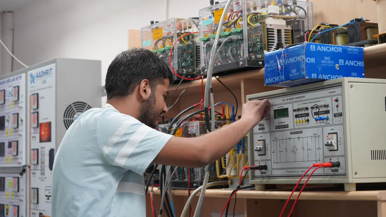 Technician inspecting electrical connections on a wall-mounted charger