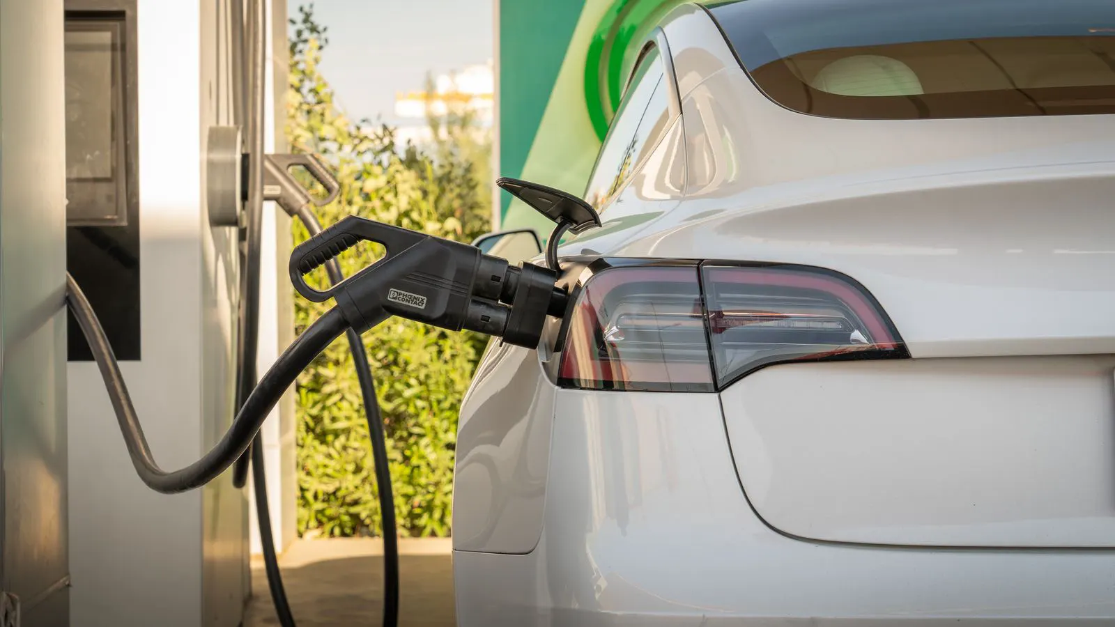 Technician examining internal wiring of an EV charging unit