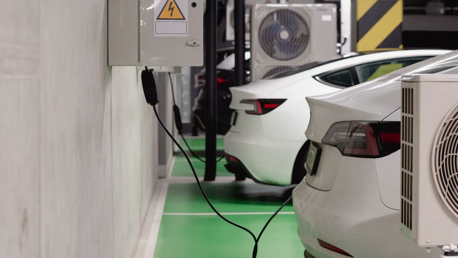 A wall mounted EV charger connected to an electrical panel