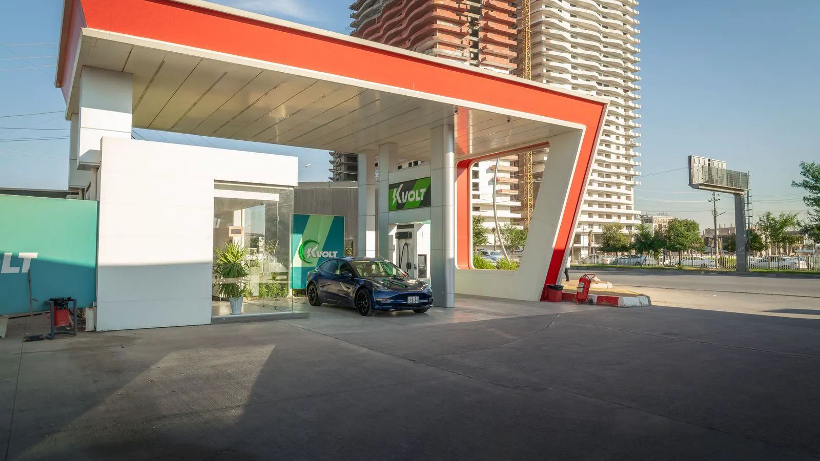 A modern electric vehicle charging station parked at a commercial lot