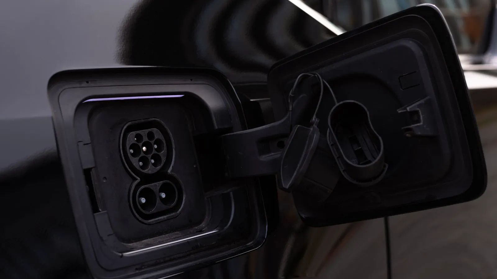 Close-up view of a DC fast charging port on an electric vehicle