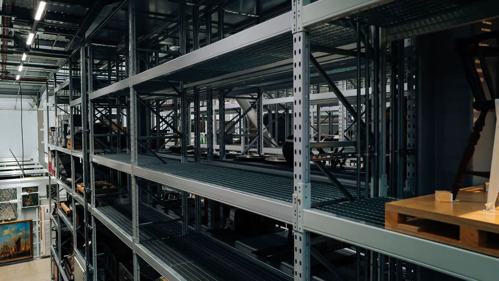 Industrial warehouse holding racks of electric vehicle charging equipment
