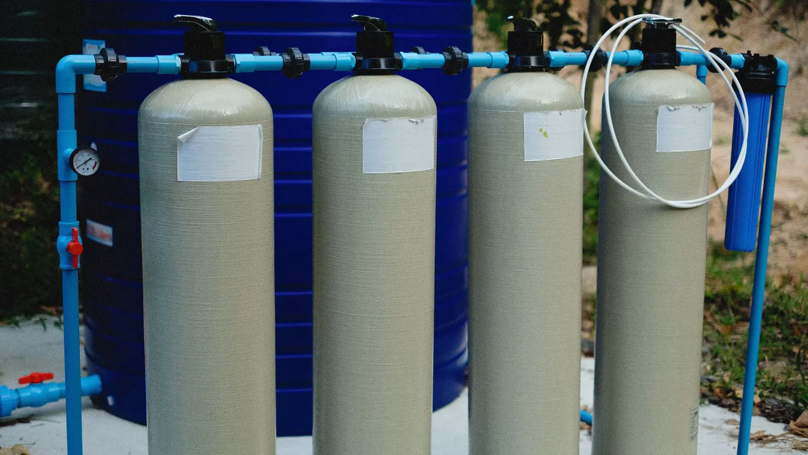 A large stainless steel media filter tank in a utility plant
