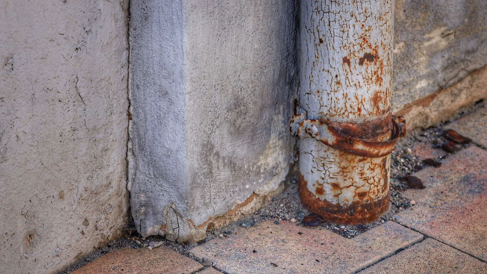 Corrosion and scale deposits visible inside a metal pipe section