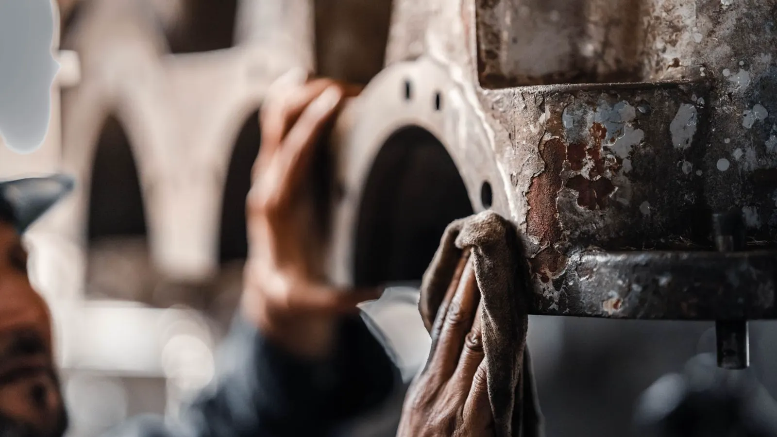 Technician inspecting the interior of a large dust collector unit.