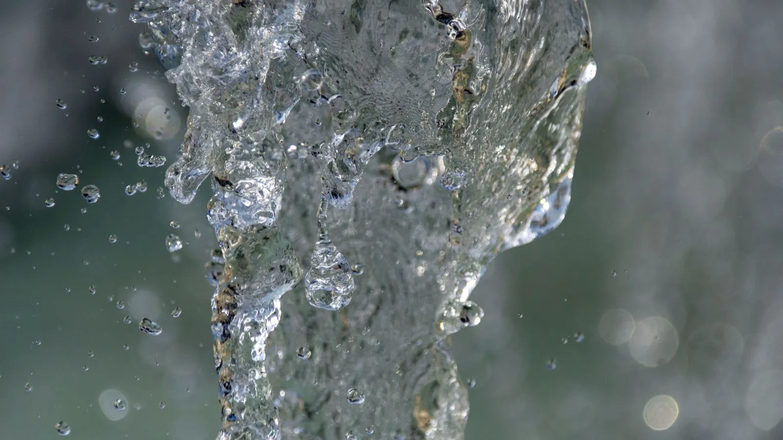 Industrial wet scrubber tower with visible liquid spray inside the vessel