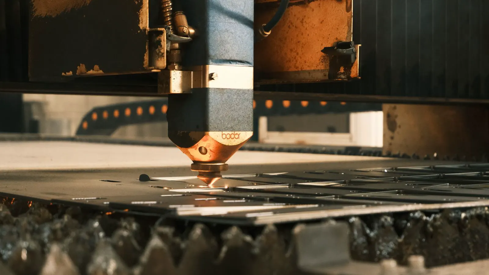 Thick steel plates stacked on a workshop floor