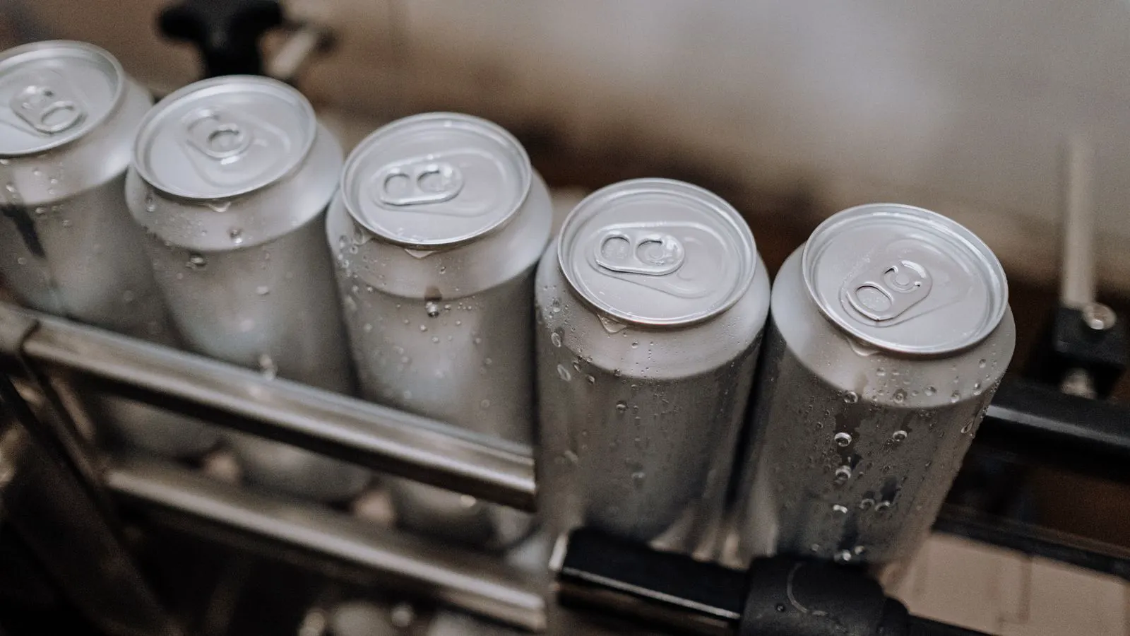 Long aluminum extrusion bars moving through a production line
