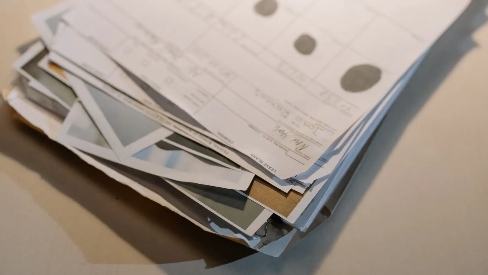 A desk with shipping papers and a metal sample