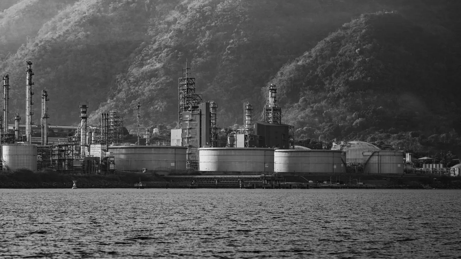 Large steel storage tanks holding sulfuric acid at a chemical facility.