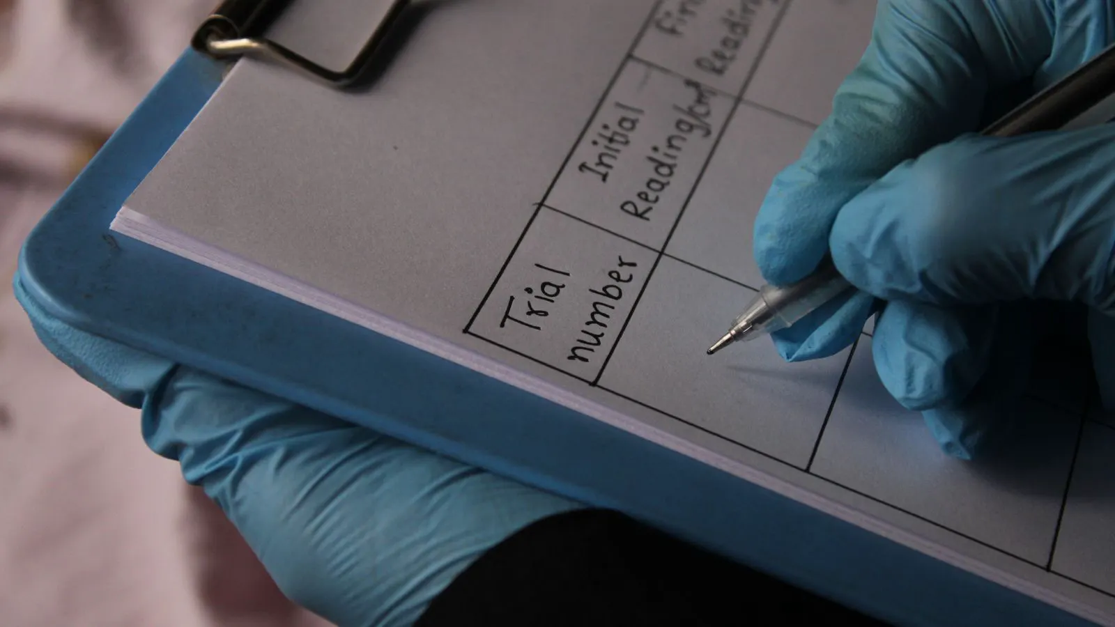A clipboard holding a printed safety data sheet next to a chemical label.