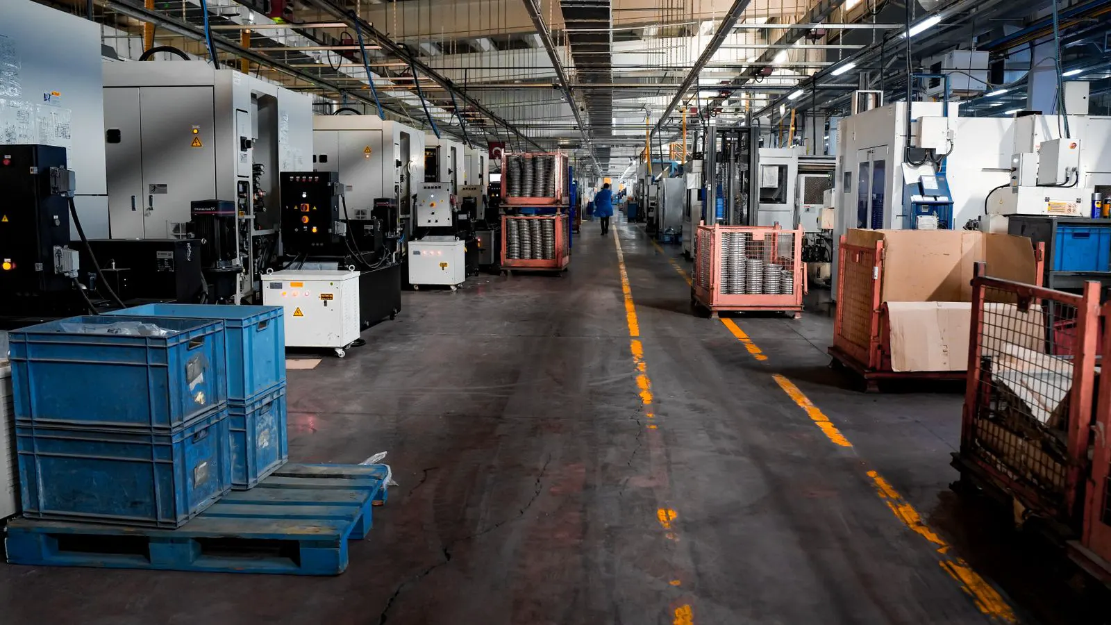 Engineer inspecting a carbon fiber panel in a clean manufacturing facility