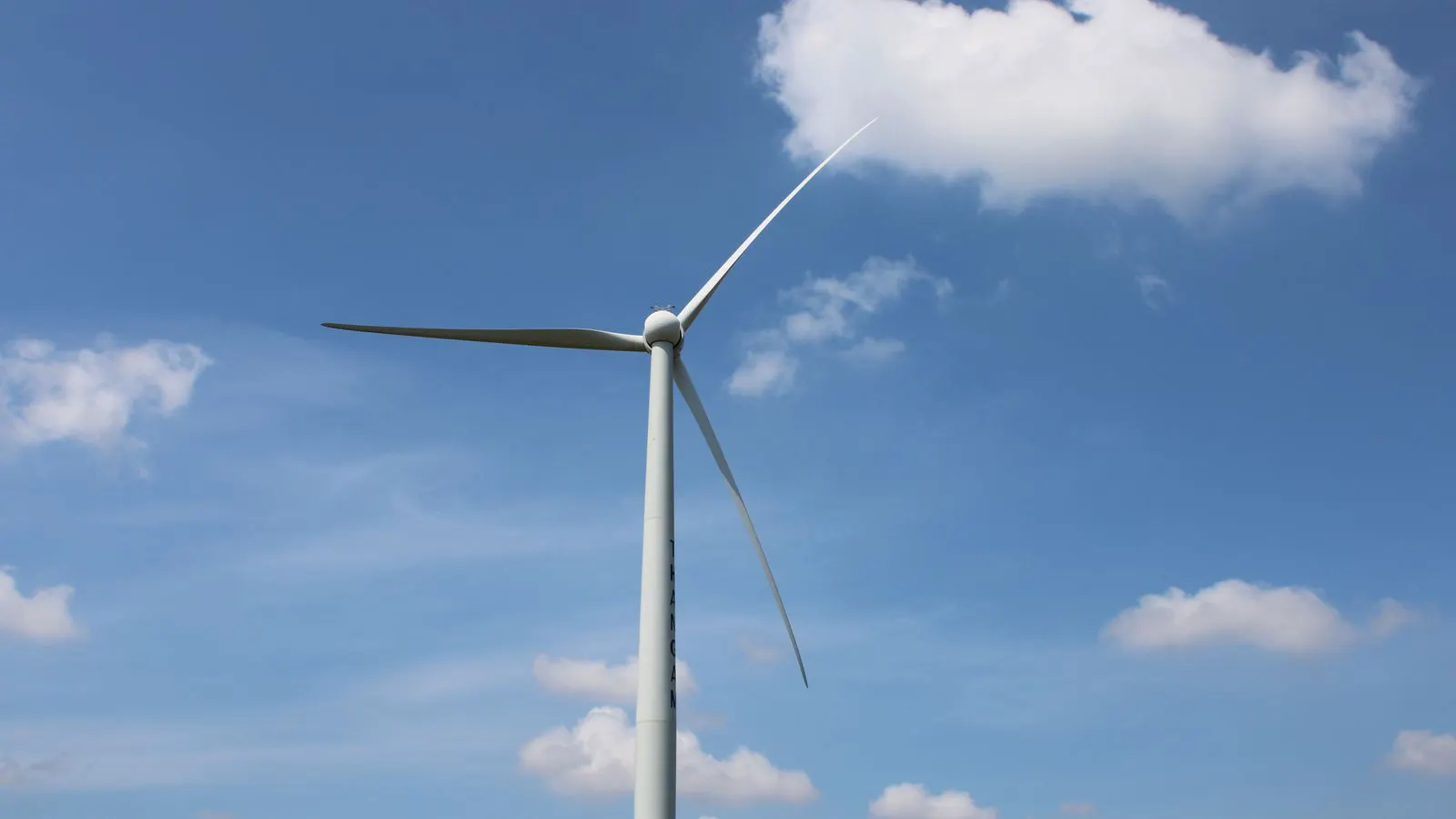 A large wind turbine blade wrapped in carbon fiber cloth