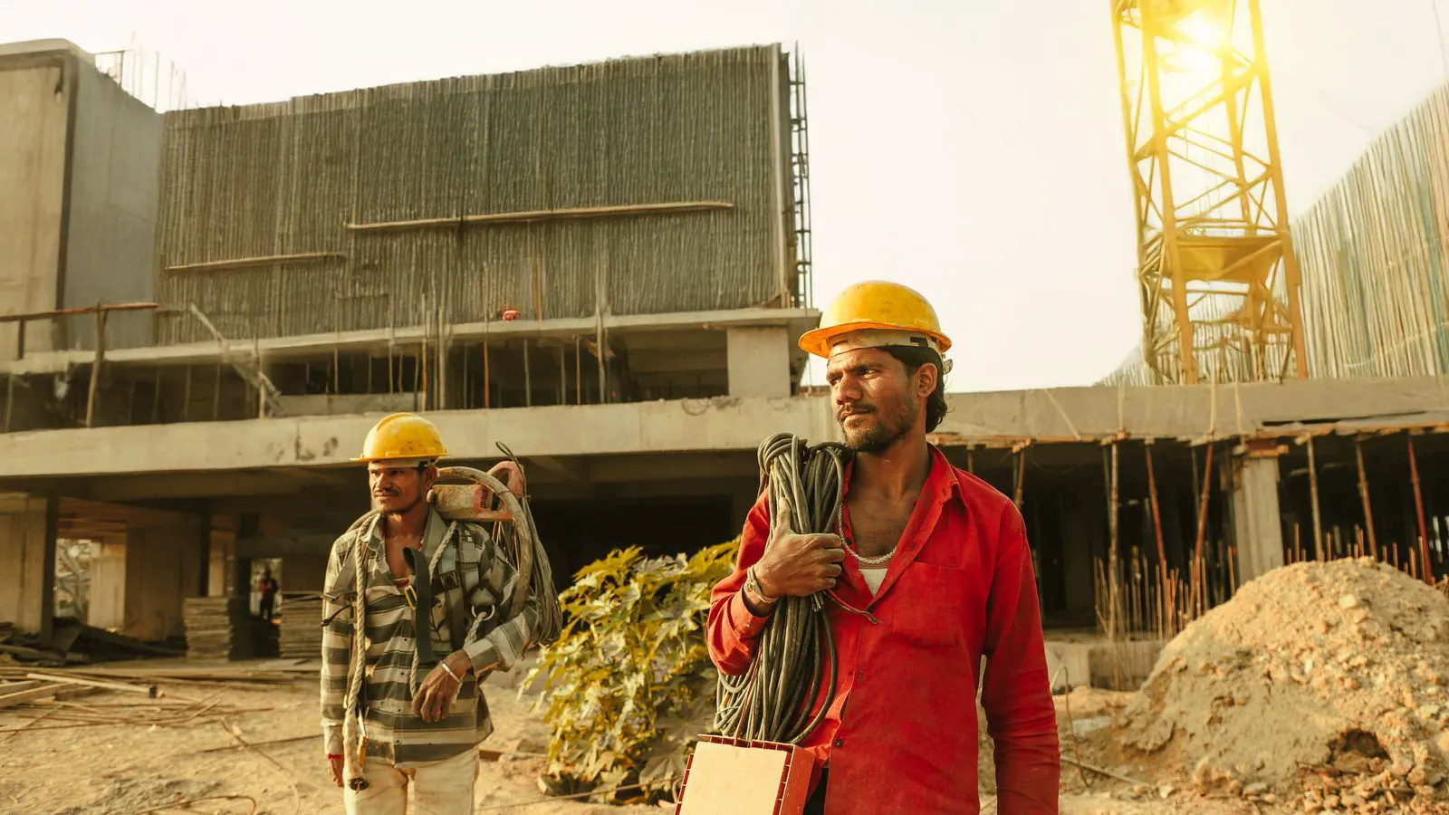 Workers and crane at a steel structure building site