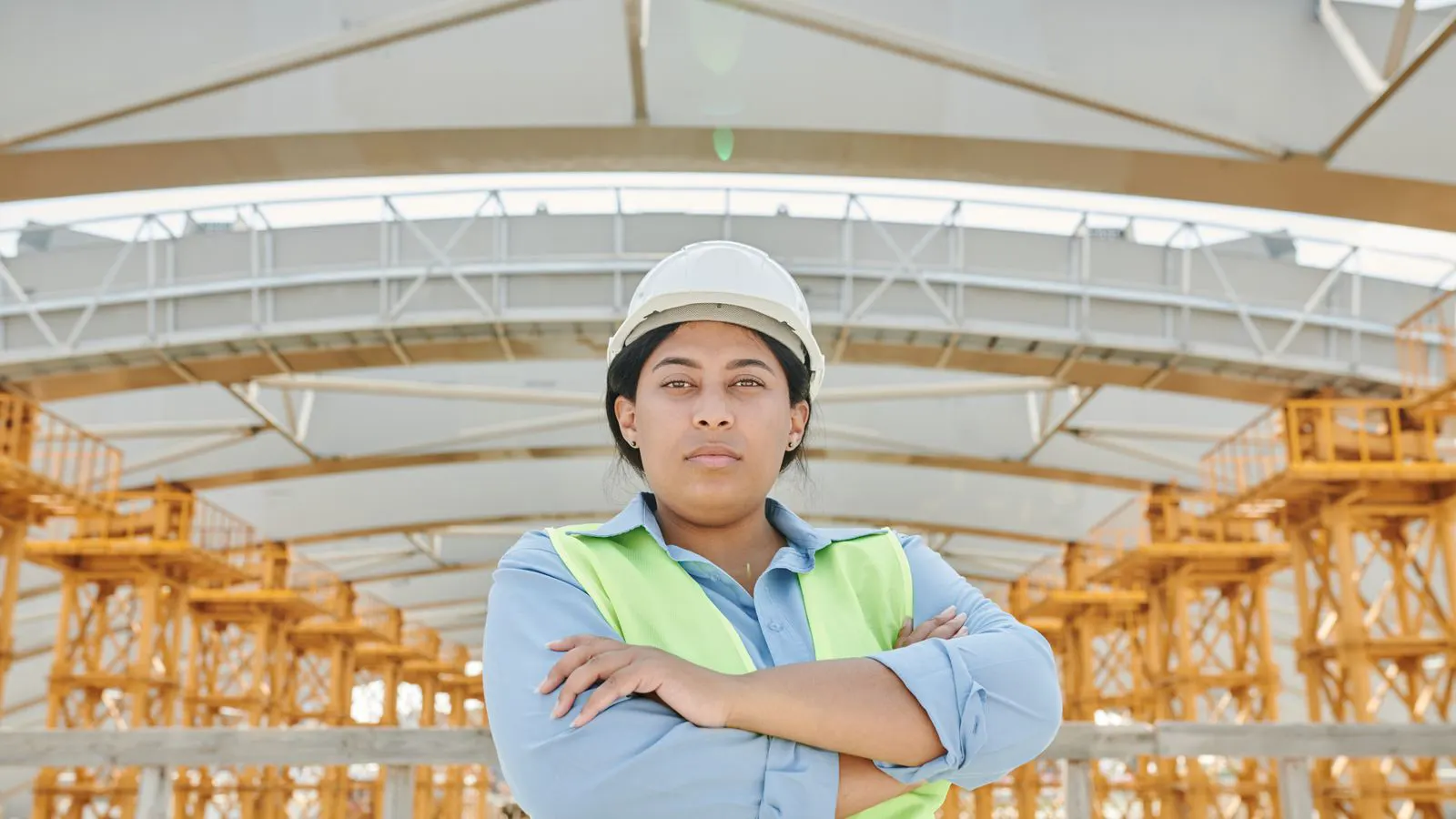 Engineers inspecting a steel frame at a fabrication facility