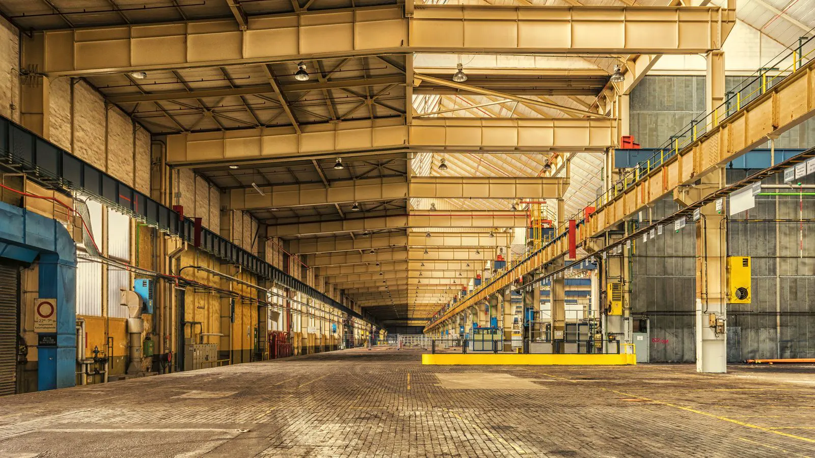 Wide view of a modern warehouse with exposed steel trusses