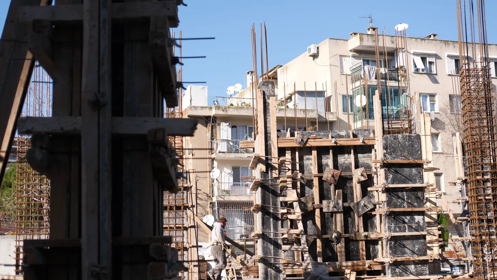 A partially built structure showing vertical steel studs and horizontal plates