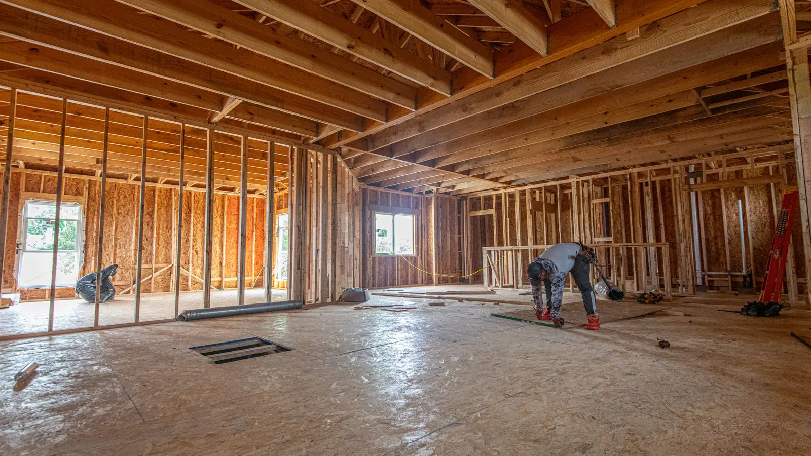 Exposed steel studs and beams of an unfinished residential structure.