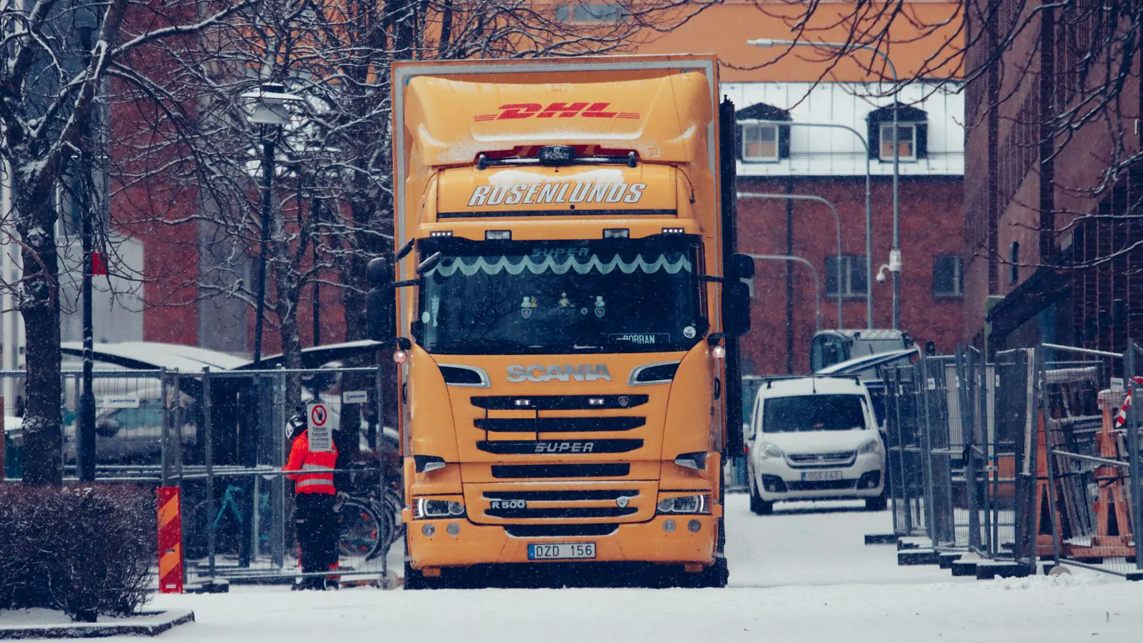 A large modular building section loaded on a heavy transport truck